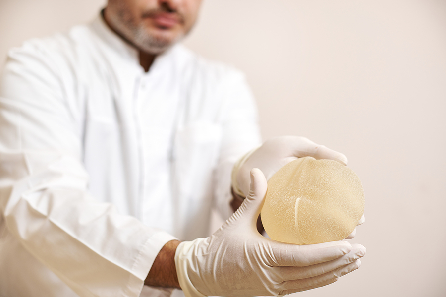 Breast Surgeon In Southeast Melbourne Holding A Breast Implant