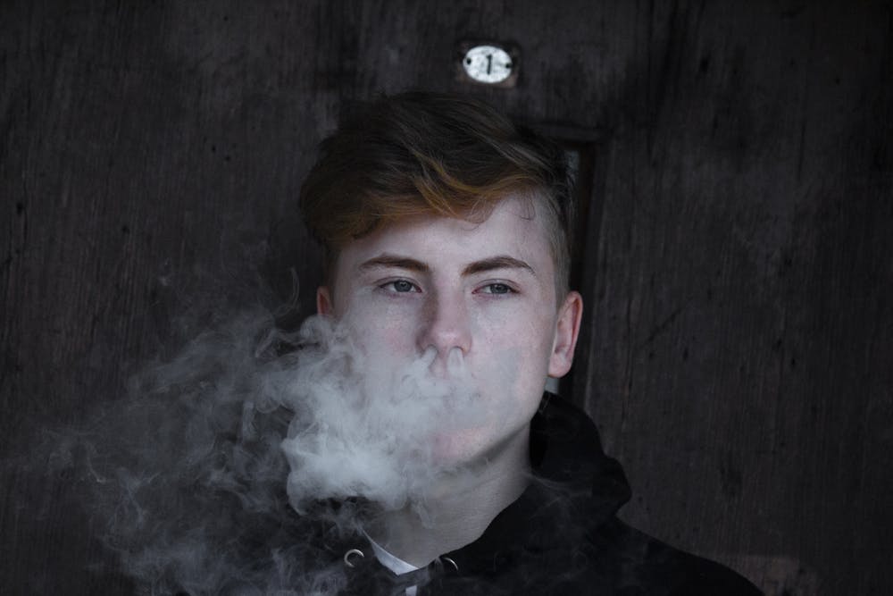 Young Man With Smoke Coming Out From His Nose