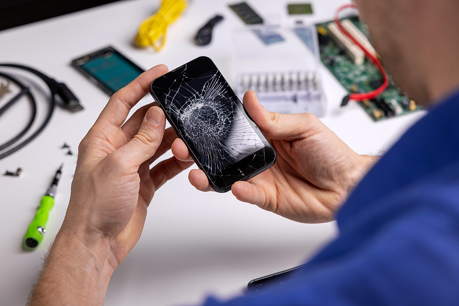 Samsung repair Sydney technician holding a broken phone